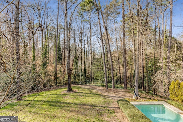 view of yard with a forest view