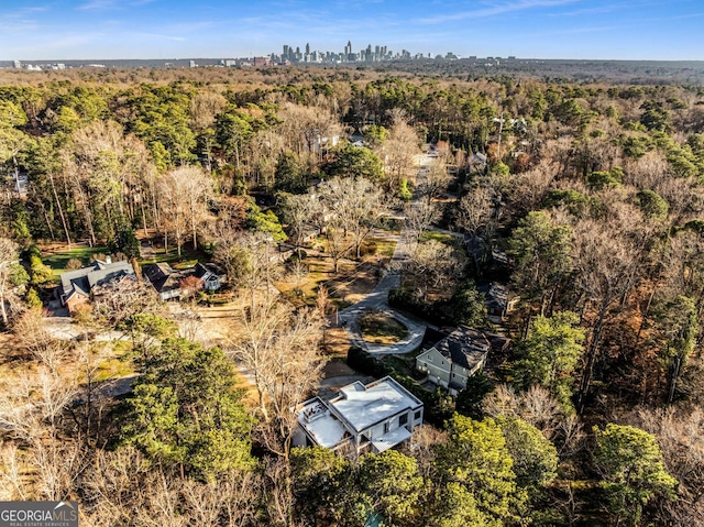 bird's eye view with a wooded view