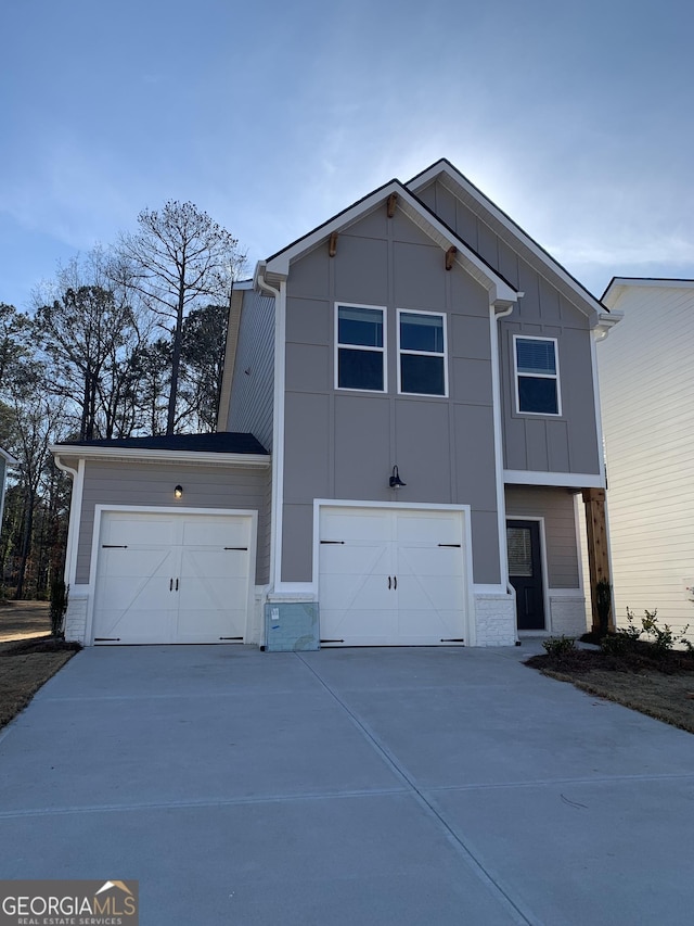 view of home's exterior with board and batten siding, brick siding, and driveway