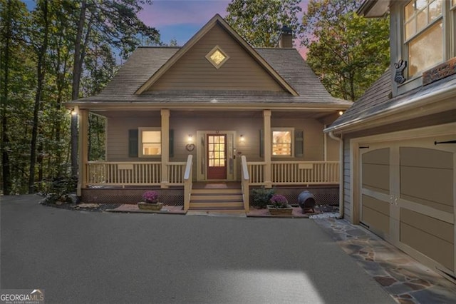 view of front of house featuring covered porch and a garage