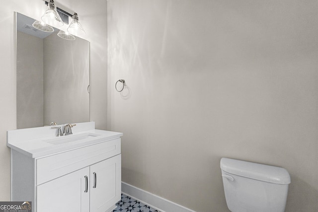 bathroom featuring vanity and toilet