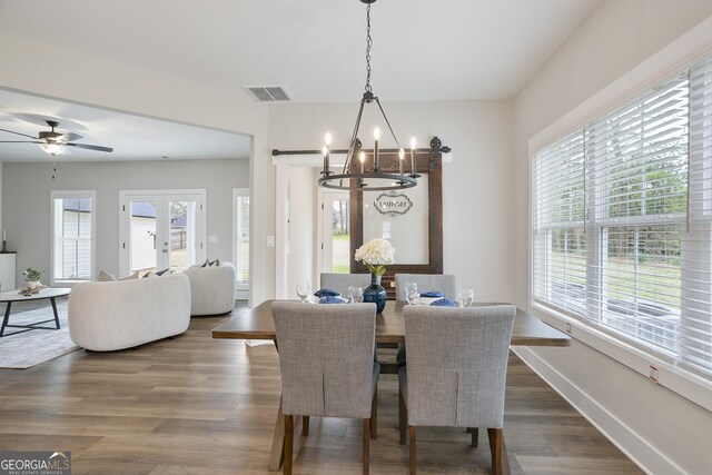 kitchen featuring white cabinets, pendant lighting, double oven, and sink