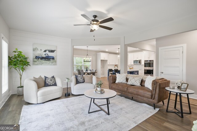 unfurnished living room with french doors, dark hardwood / wood-style flooring, a brick fireplace, and ceiling fan