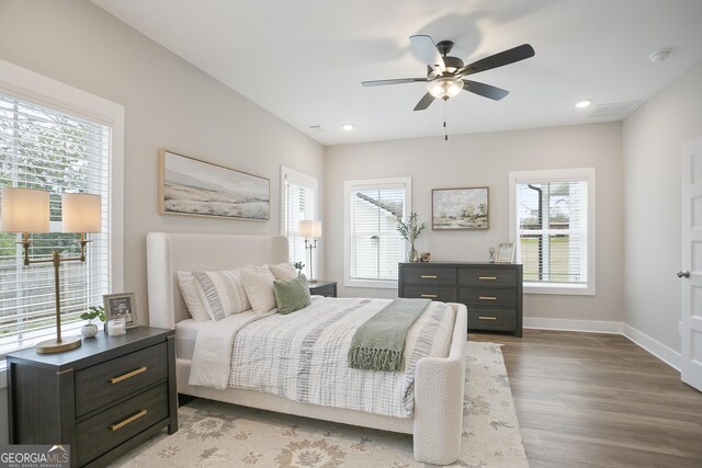 unfurnished room with ceiling fan, dark wood-type flooring, and a healthy amount of sunlight