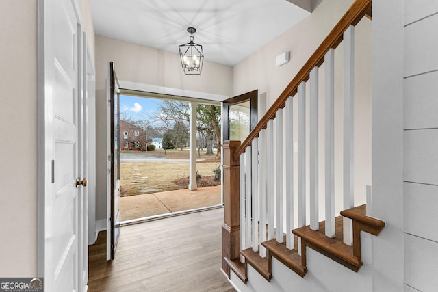 entryway with a chandelier and light hardwood / wood-style floors