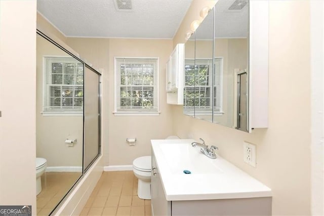 full bathroom with vanity, toilet, a textured ceiling, and shower / bath combination with glass door