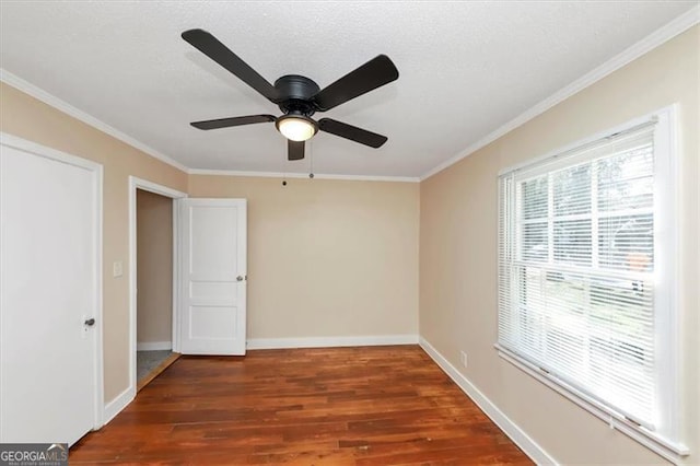 unfurnished room featuring ceiling fan, crown molding, a textured ceiling, and dark hardwood / wood-style floors