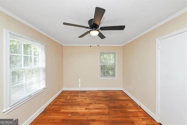 unfurnished room with ornamental molding, hardwood / wood-style floors, plenty of natural light, and ceiling fan