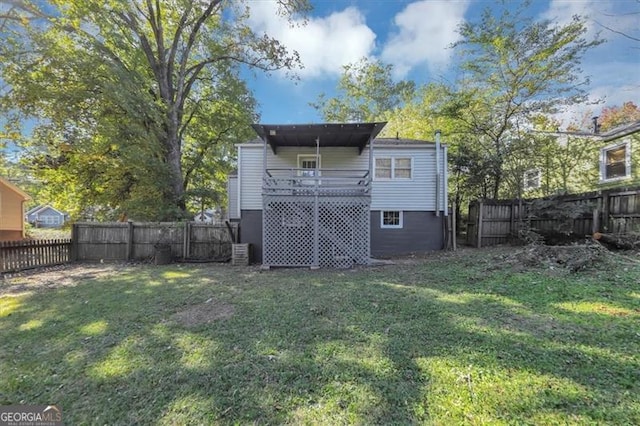 rear view of property featuring a yard