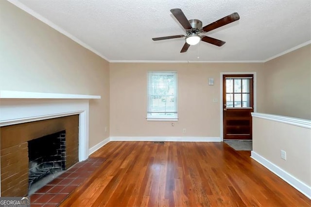 unfurnished living room featuring ornamental molding, dark hardwood / wood-style floors, a textured ceiling, and a fireplace