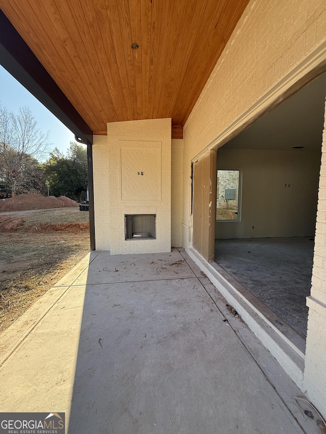 view of patio featuring a fireplace