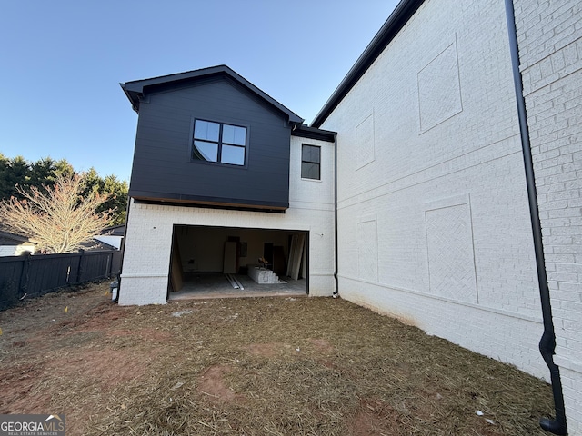 rear view of house with a garage