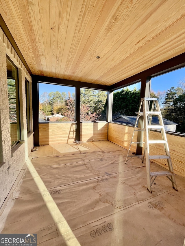 unfurnished sunroom featuring wood ceiling