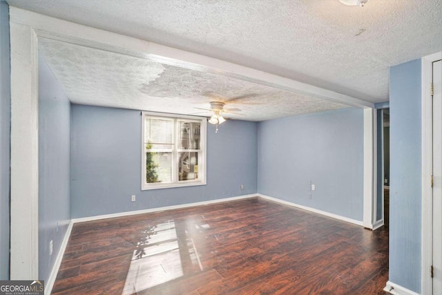 spare room featuring a textured ceiling, dark hardwood / wood-style floors, and ceiling fan