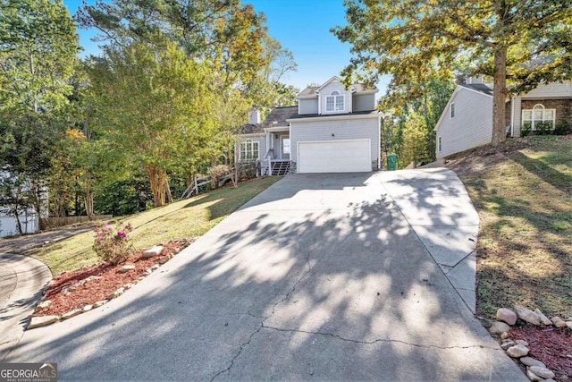 view of front facade with a front yard and a garage