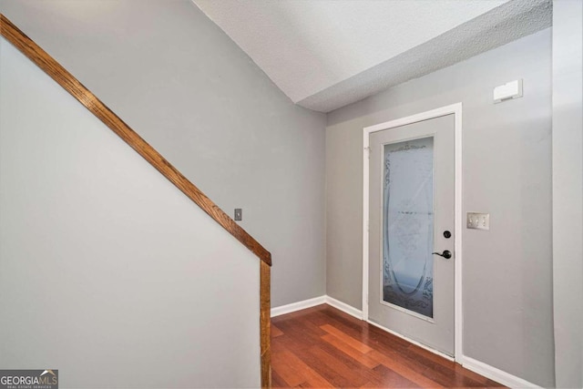 foyer featuring a textured ceiling and dark hardwood / wood-style flooring