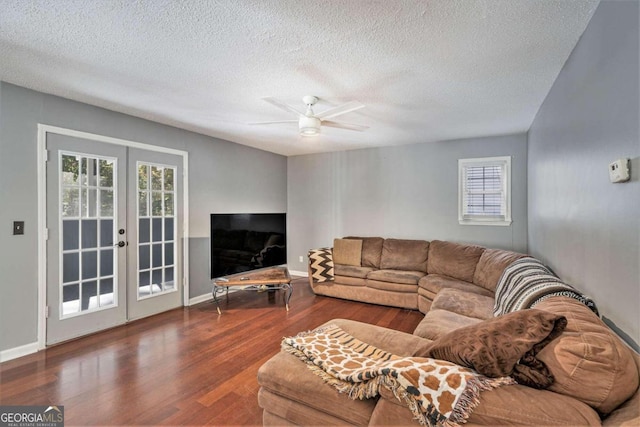 living room featuring french doors, dark hardwood / wood-style floors, a textured ceiling, and ceiling fan