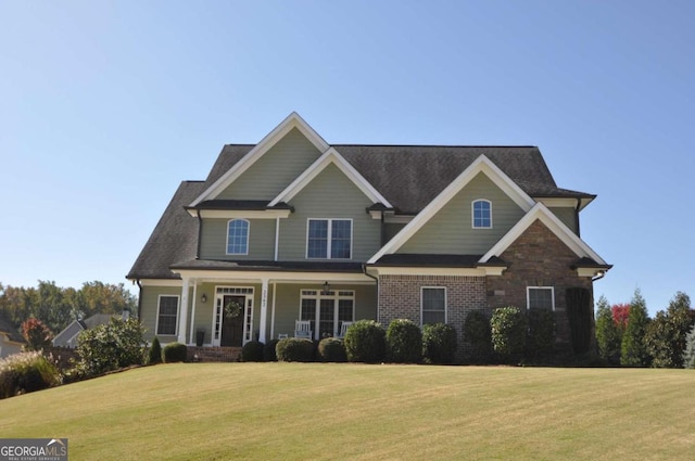 craftsman-style home featuring a porch and a front lawn