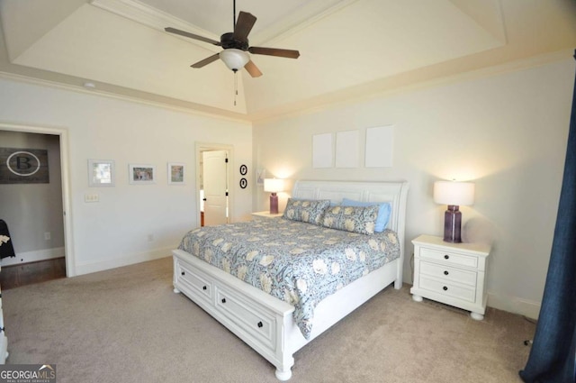 bedroom featuring light carpet, crown molding, and ceiling fan