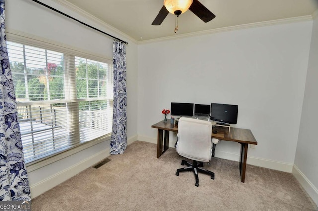 carpeted office space featuring a wealth of natural light, ornamental molding, and ceiling fan