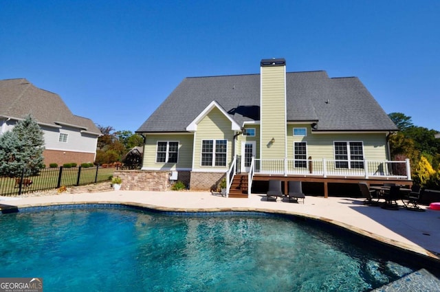 rear view of property featuring a patio and a pool side deck