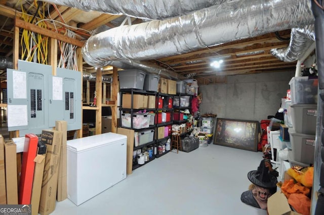 basement with fridge and electric panel