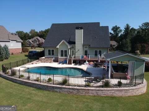 view of swimming pool with a patio area and a yard