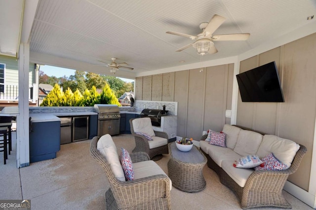 view of patio / terrace featuring ceiling fan, exterior kitchen, an outdoor hangout area, and a grill