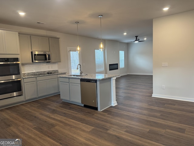 kitchen with dark hardwood / wood-style flooring, sink, gray cabinetry, and stainless steel appliances