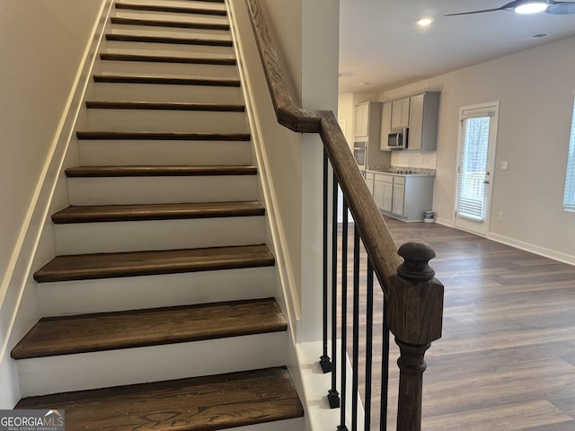 stairs featuring hardwood / wood-style flooring