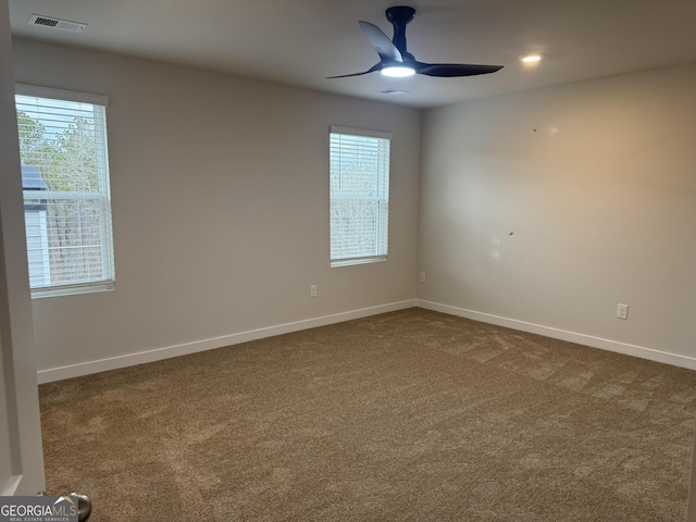 carpeted empty room featuring ceiling fan