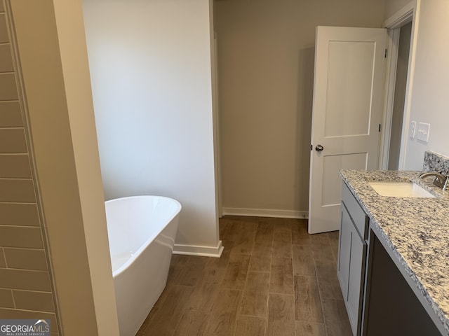 bathroom featuring a bath and vanity