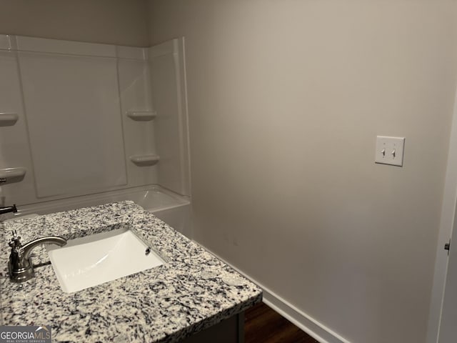 bathroom featuring bathtub / shower combination and vanity