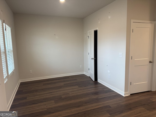 spare room featuring dark hardwood / wood-style flooring