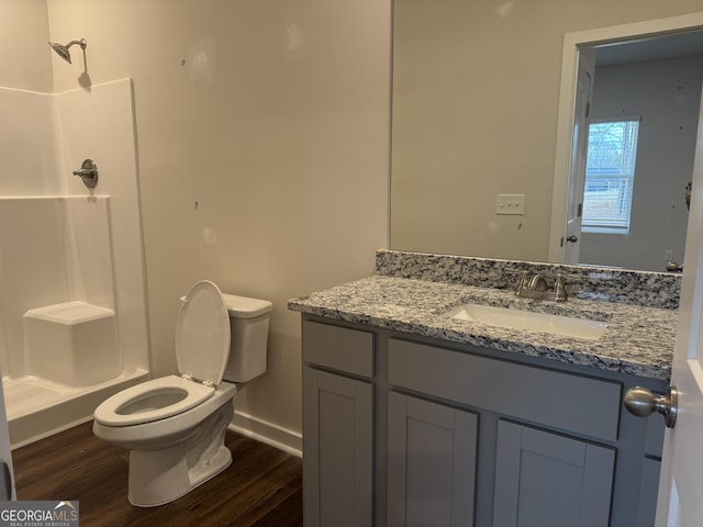 bathroom with toilet, walk in shower, hardwood / wood-style flooring, and vanity