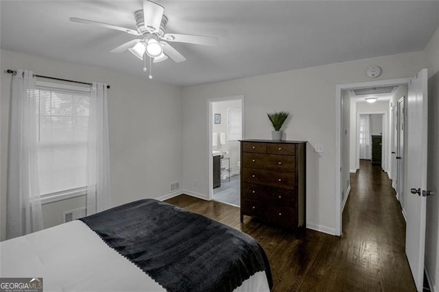 bedroom featuring connected bathroom, dark hardwood / wood-style floors, and ceiling fan