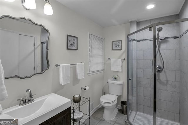 bathroom featuring tile patterned flooring, vanity, toilet, and an enclosed shower