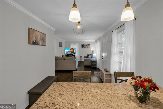 dining space with dark wood-type flooring and ornamental molding