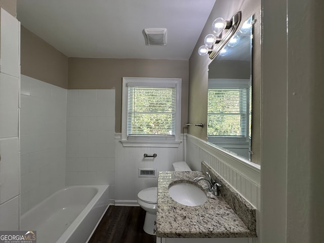 full bathroom with  shower combination, vanity, hardwood / wood-style floors, and toilet