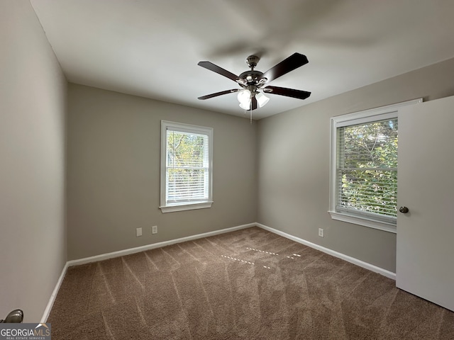 spare room featuring ceiling fan and carpet floors