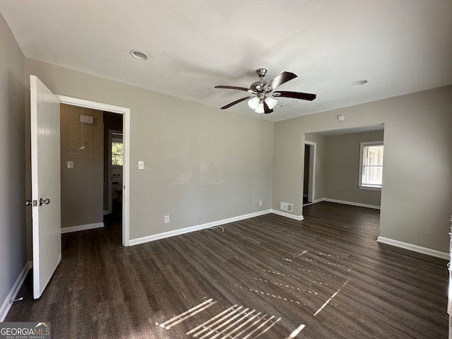 unfurnished room with ceiling fan and dark hardwood / wood-style flooring