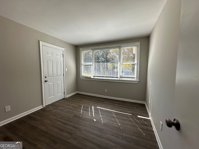 empty room featuring dark hardwood / wood-style flooring