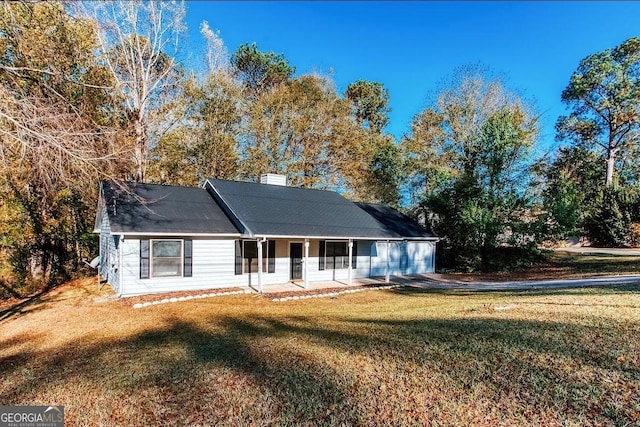 view of front facade featuring a front lawn, a porch, and a garage