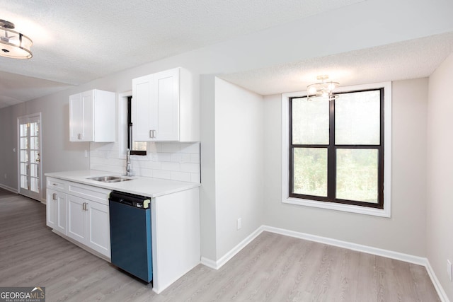 kitchen featuring dishwasher, white cabinets, a wealth of natural light, and sink