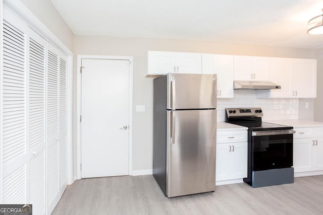 kitchen featuring tasteful backsplash, white cabinetry, light hardwood / wood-style flooring, and appliances with stainless steel finishes