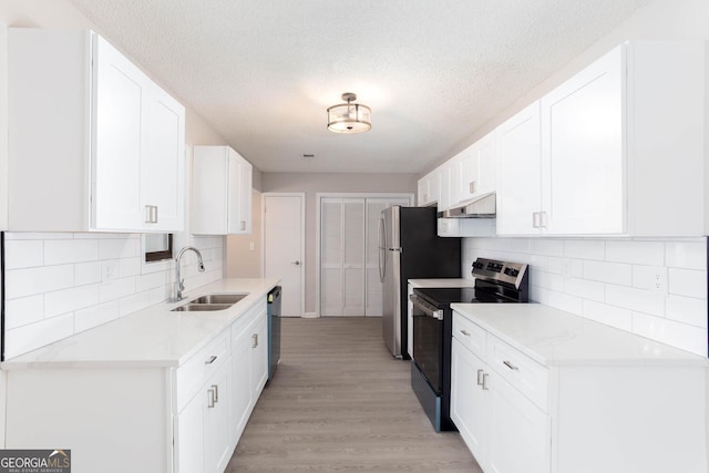 kitchen featuring white cabinetry, sink, stainless steel electric range, and light wood-type flooring