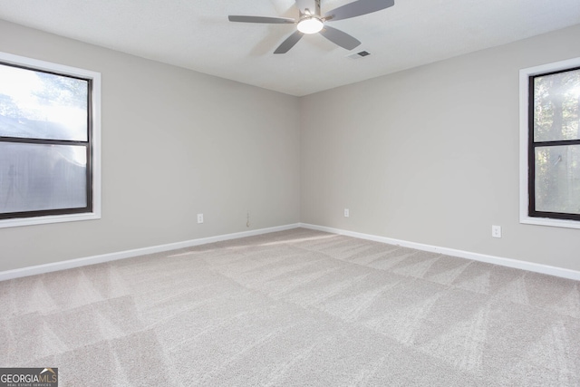 carpeted empty room featuring ceiling fan