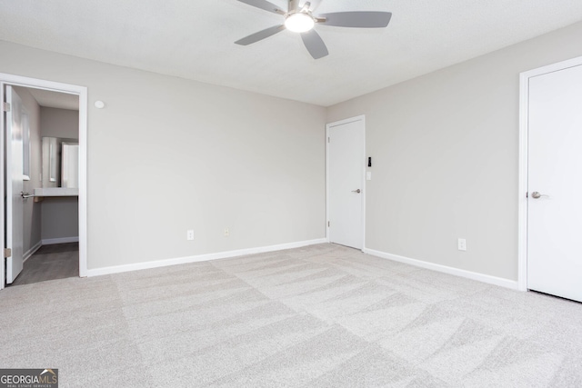 empty room with ceiling fan and light colored carpet