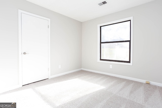 empty room featuring light carpet