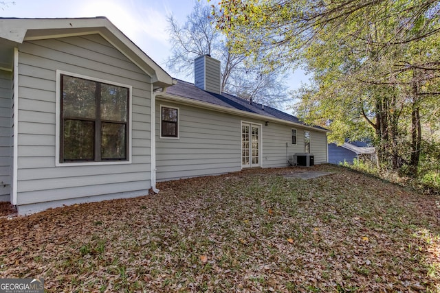 rear view of house with central air condition unit